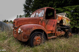 A series of photos taken using the headlamps of wrecked cars as the focus point.