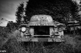 A series of photos taken using the headlamps of wrecked cars as the focus point.