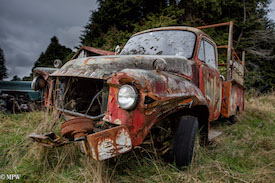 A series of photos taken using the headlamps of wrecked cars as the focus point.