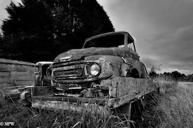 A series of photos taken using the headlamps of wrecked cars as the focus point.