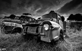 A series of photos taken using the headlamps of wrecked cars as the focus point.