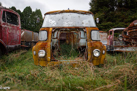 A series of photos taken using the headlamps of wrecked cars as the focus point.