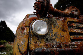 A series of photos taken using the headlamps of wrecked cars as the focus point.