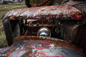 A series of photos taken using the headlamps of wrecked cars as the focus point.