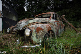 A series of photos taken using the headlamps of wrecked cars as the focus point.