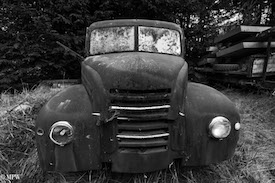 A series of photos taken using the headlamps of wrecked cars as the focus point.