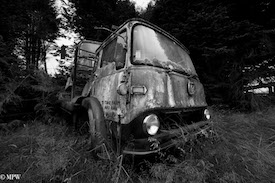 A series of photos taken using the headlamps of wrecked cars as the focus point.