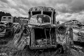 A series of photos taken using the headlamps of wrecked cars as the focus point.