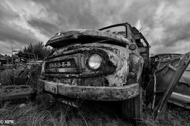 A series of photos taken using the headlamps of wrecked cars as the focus point.