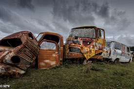 A series of photos taken using the headlamps of wrecked cars as the focus point.