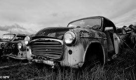 A series of photos taken using the headlamps of wrecked cars as the focus point.