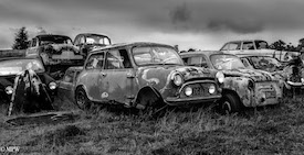 A series of photos taken using the headlamps of wrecked cars as the focus point.