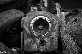 A series of photos taken using the headlamps of wrecked cars as the focus point.