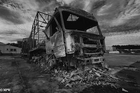 A series of photos taken using the headlamps of wrecked cars as the focus point.