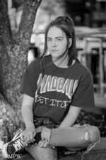 Pretty teen girl taking a break under a tree in Queen Street, Auckland
