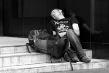 Powernap on a city office building steps Queen St, Auckland, black and white